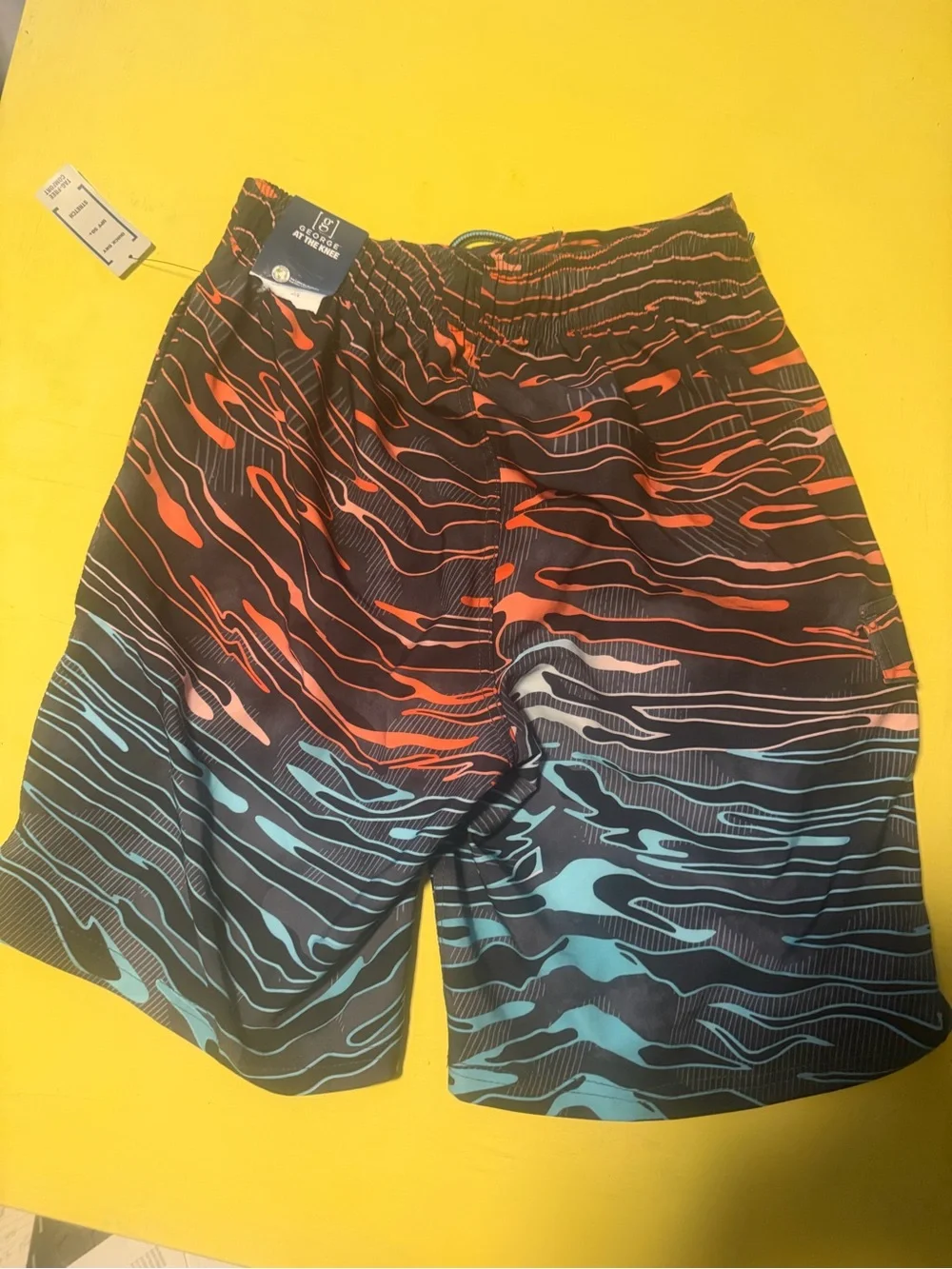 Men's size small nwtBlack Swim Trunks with Red & Teal Wave Print